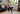 Senior woman performing a banded squat with a resistance band in her home
