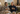 Senior couple sitting on couch drinking herbal tea in winter