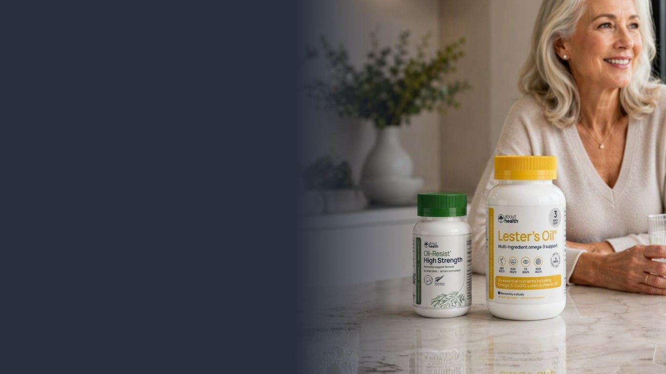 Bottle of Oli-Resist High-Strength and Lester's Oil on table with senior active healthy woman holding glass of water