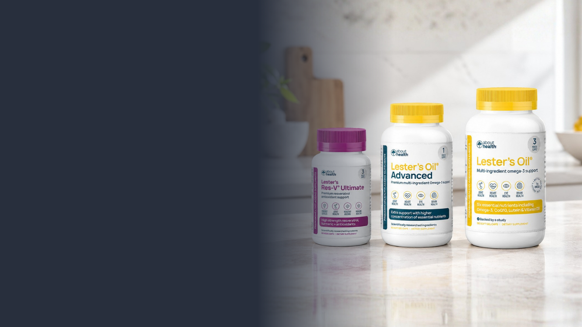 Three white supplement bottles with yellow Lester's Oil and Lester's Oil Advanced lids and purple Res-V Ultimate lid lined up on a light countertop in a kitchen setting.