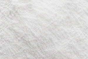 A close-up texture shot of a white Betaine Powder
