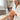 Elder woman applying the Magnesium & Kawakawa Body Cream to support legs