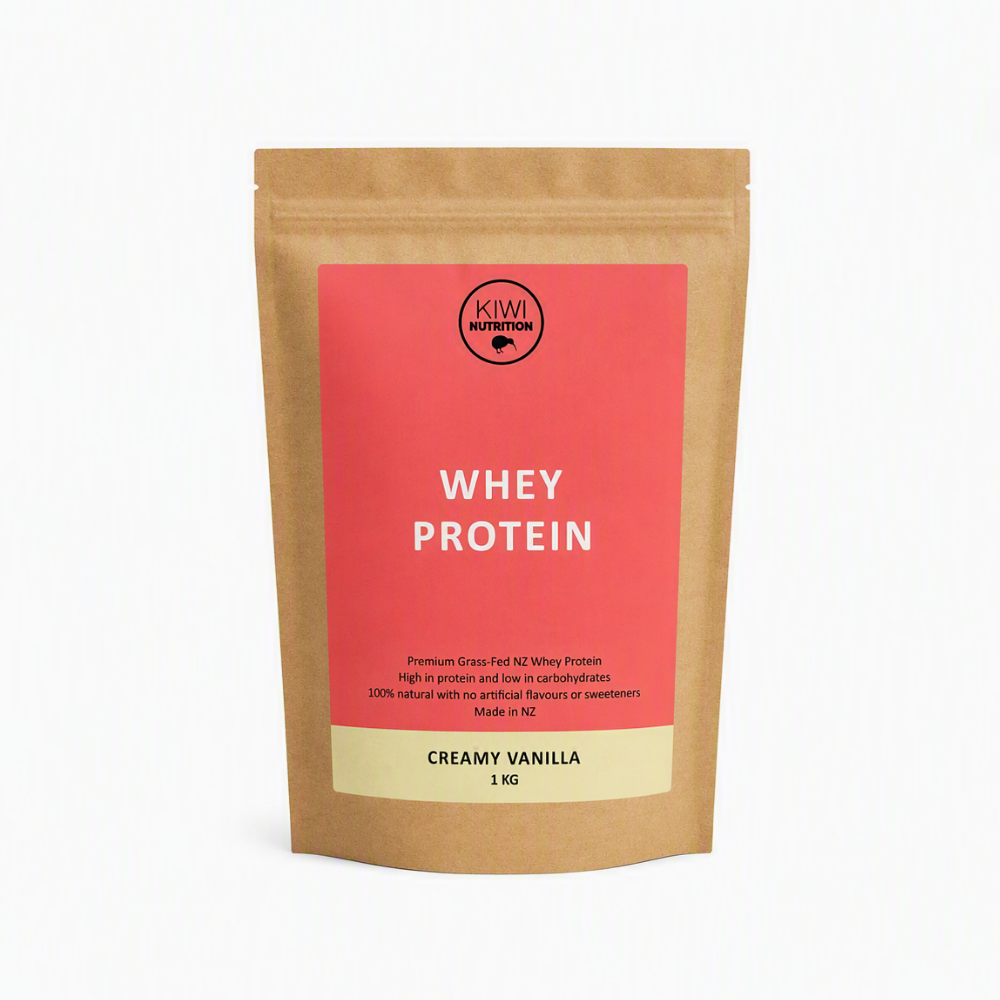 A 1 kg stand-up pouch of Kiw Nutrition Whey Protein in Creamy Vanilla flavor, made from brown kraft paper with a coral pink label and a beige bottom section.