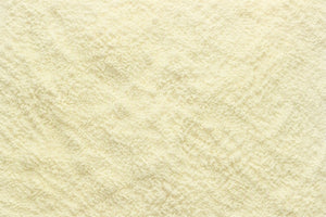 A close-up texture shot of a fine, light cream-colored Quercetin Phytosome Powder