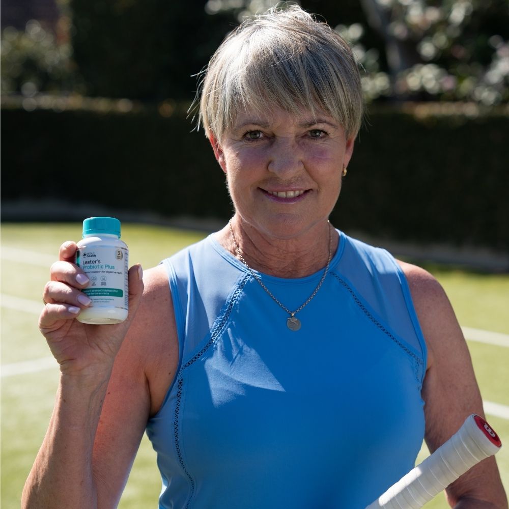 Active woman holding a bottle of Lester's Probiotic Plus.