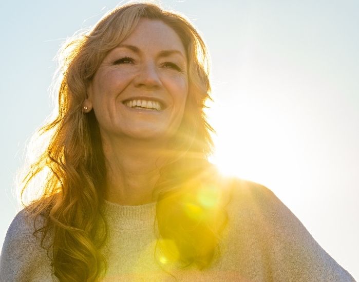 Happy woman outdoors, representing hormonal balance