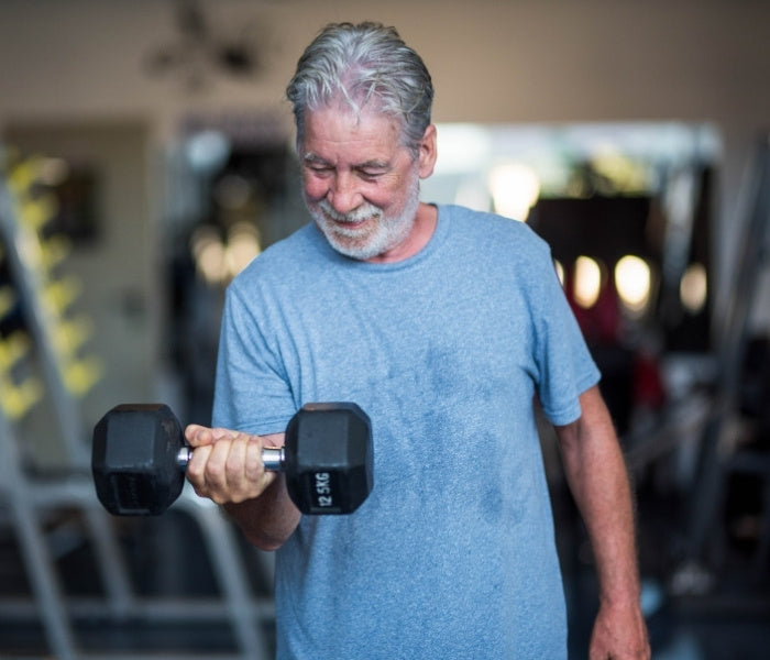 Man exercising with a dumbbell in a gym setting