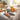 Woman holding yellow massage roller in hand on the couch